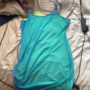 The color of the dress has a lime green slit under it with a blue mesh coat.